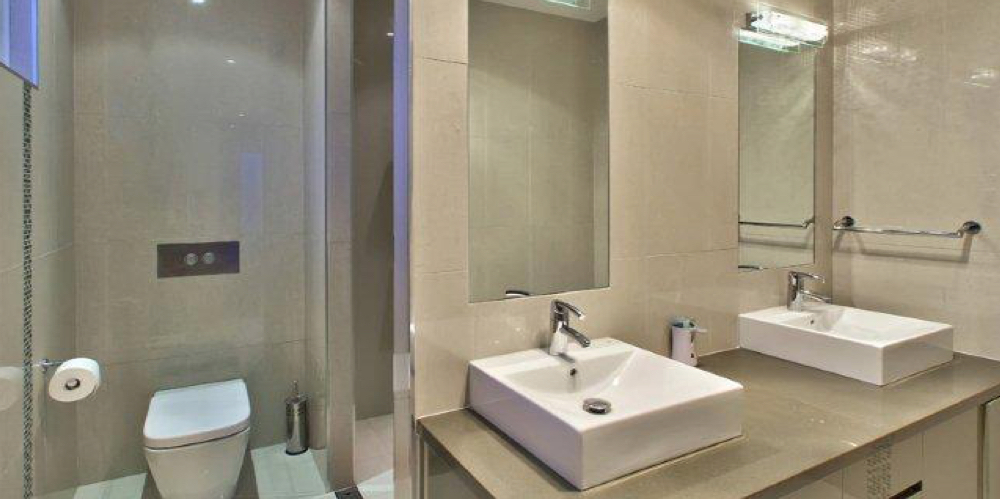 Bathroom with double vessel basins and wall-mounted chrome mixers