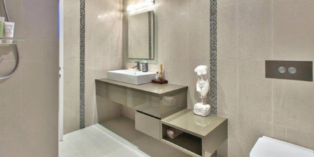 Finished bathroom with bath, vanity and heated towel rail