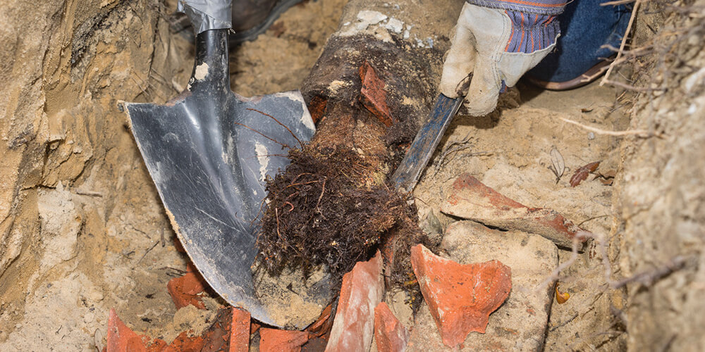 Stormwater drain being cleared with a rotary drain machine