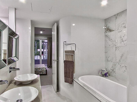 Ensuite bathroom with double vessel basins and wall-mounted chrome mixers