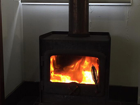 Wood heater flue and gas fitting in a Brisbane home