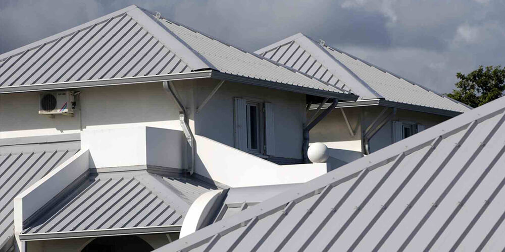 Accuplumb plumber inspecting roof guttering on a Brisbane building